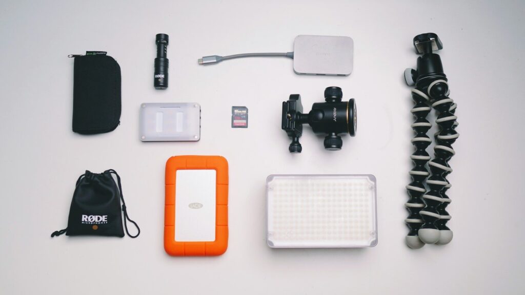 A selection of camera accessories on a wooden surface.
