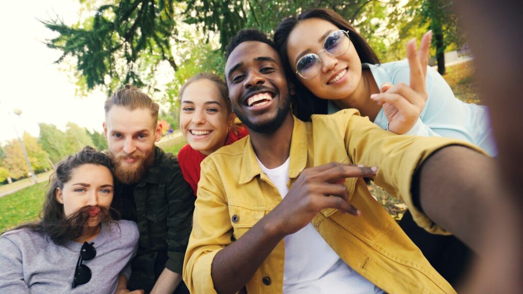 Diverse friends posing outdoors for creative photos.